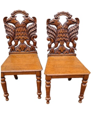 A   pair of Victorian oak hall chairs